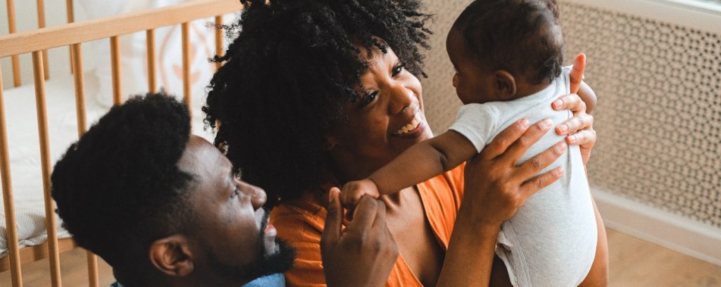 Parents smiling at baby